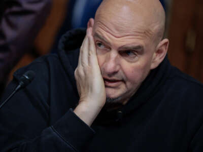 Senate Homeland Security and Governmental Affairs Committee member Sen. John Fetterman prepares to vote to advance Sen. Markwayne Mullin to be Secretary of the Department of Homeland Security during a markup hearing in the Dirksen Senate Office Building on Capitol Hill on March 19, 2026, in Washington, D.C.