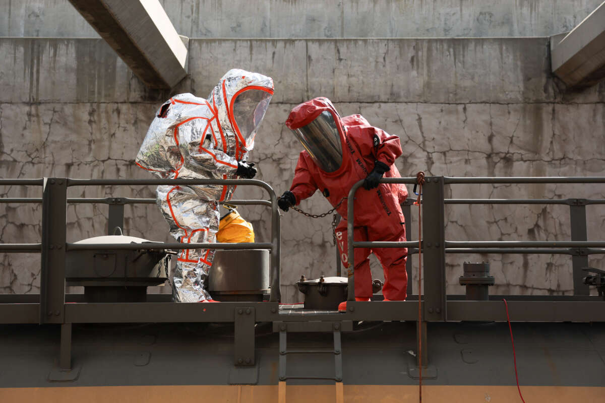 Firefighters wear hazmat suits while inspecting tanker cars during a chlorine leak trench training exercise with the Alameda Corridor Transportation Authority (ACTA) to prepare for an industrial accident or disaster in Compton, California, on March 22, 2026.