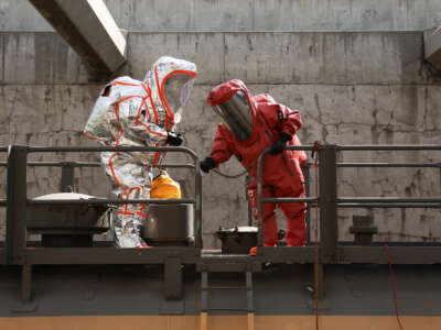 Firefighters wear hazmat suits while inspecting tanker cars during a chlorine leak trench training exercise with the Alameda Corridor Transportation Authority (ACTA) to prepare for an industrial accident or disaster in Compton, California, on March 22, 2026.