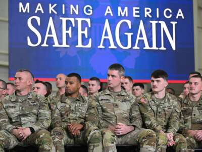 Members of the U.S. military listen as Donald Trump speaks during the Memphis Safe Task Force roundtable in Memphis, Tennessee, on March 23, 2026.