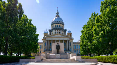 General views of the Illinois State Capitol Building, featuring a statue of Abraham Lincoln at the steps leading to the entrance of the capitol on May 11, 2026, in Springfield, Illinois.