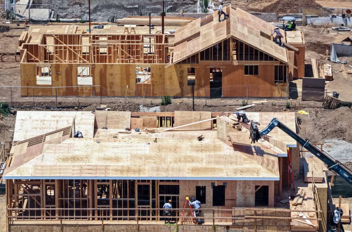 An aerial view of construction workers rebuilding houses that were destroyed in the Palisades Fire, on June 25, 2026, in Pacific Palisades, California.