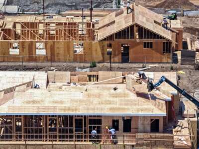An aerial view of construction workers rebuilding houses that were destroyed in the Palisades Fire, on June 25, 2026, in Pacific Palisades, California.