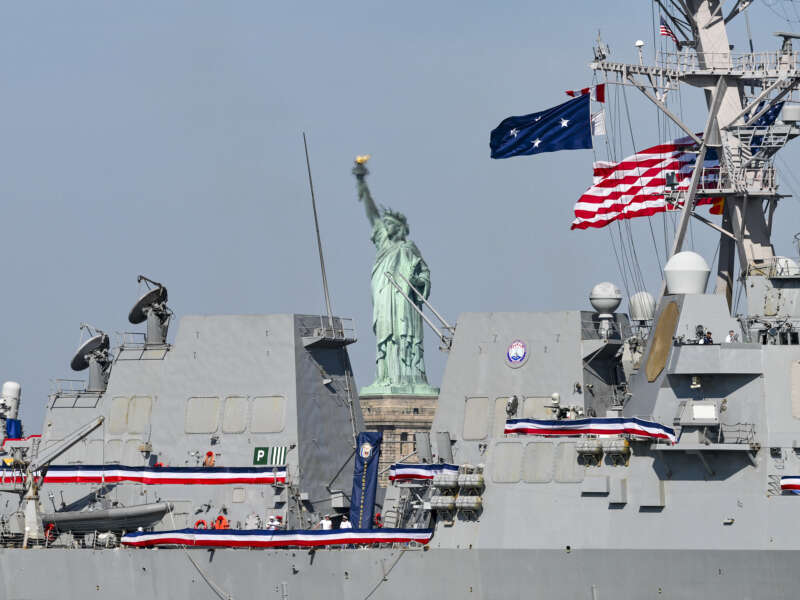 This photograph shows a view of the US Navy guided-missile destroyer Farragut and the Statue of Liberty ahead of the Sail4th 250 parade of ships in New York Harbor for the United States 250th anniversary on Independence Day in New York, on July 4, 2026.