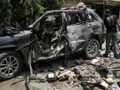 First responders inspect the wreckage of a car reportedly targeted by an Israeli strike in Nabatieh, Lebanon, on July 6, 2026.
