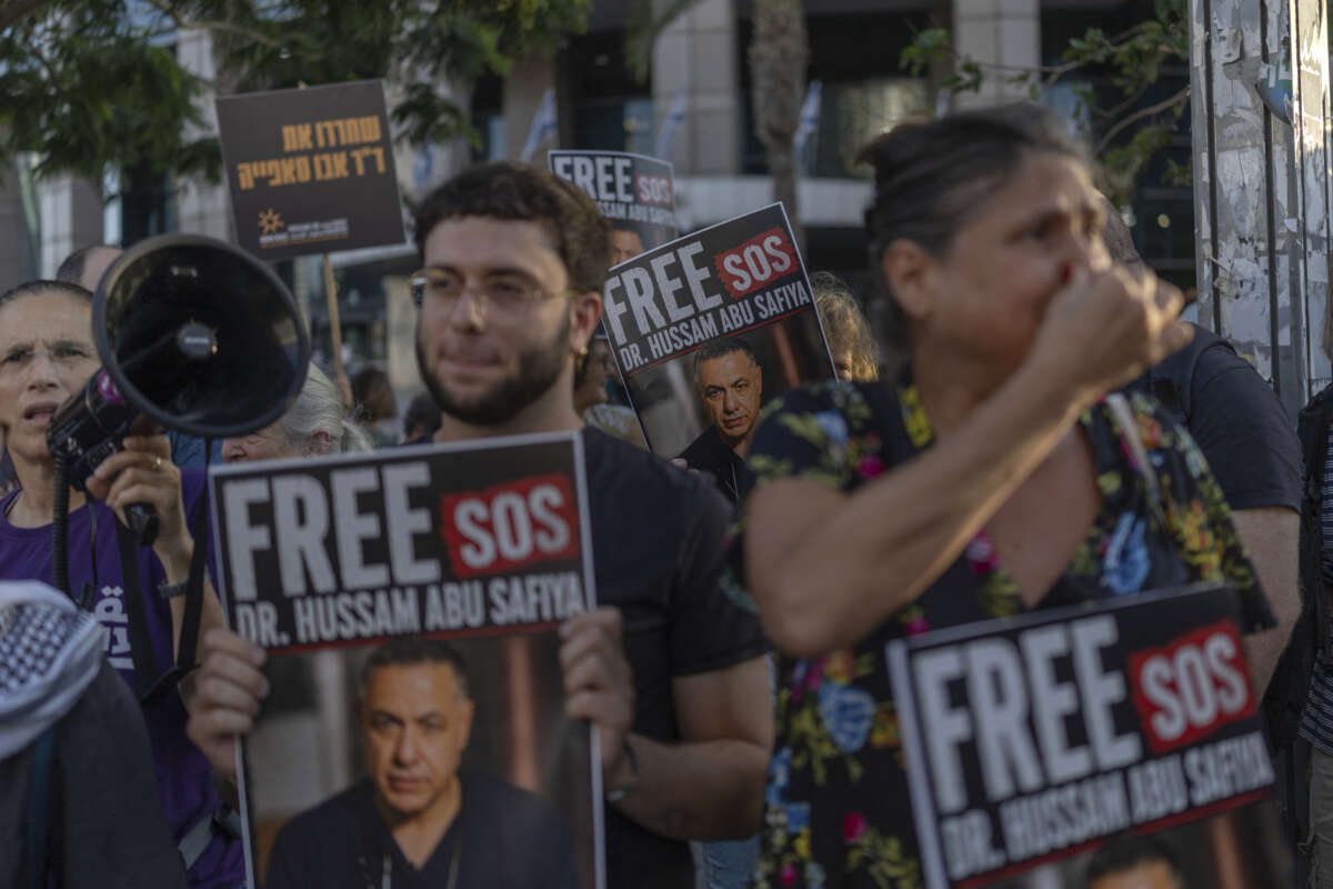 Israeli left-wing activists hold placards and chant slogans in Tel Aviv, on July 6, 2026, during a rally calling for release of Palestinian Doctor Hussan Abu Safiya, detained by Israeli forces since December 2024.