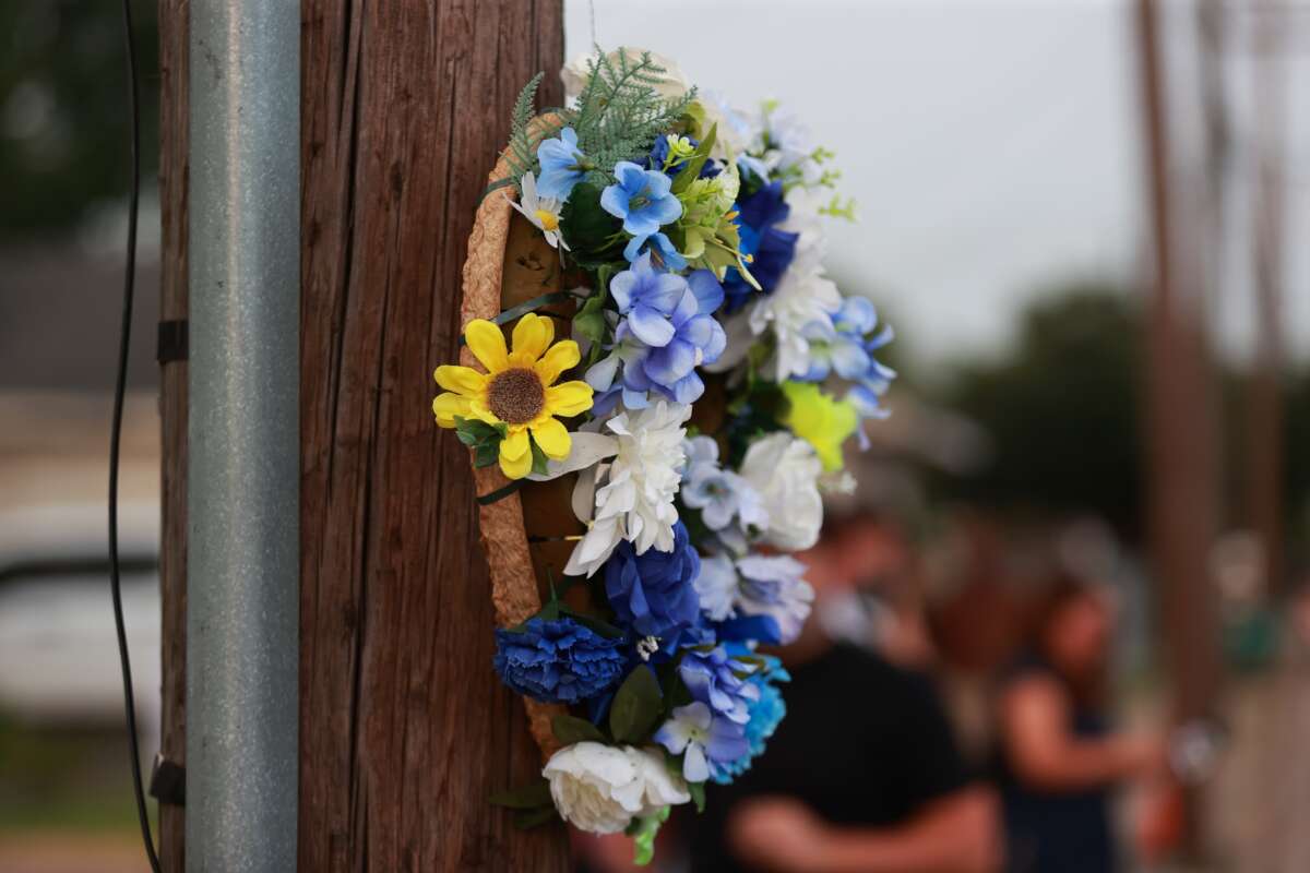 A floral wreath hangs on a utility pole near the intersection of Wayside Drive and Canal Street in Houston, Texas, on July 7, 2026, marking the location where Lorenzo Salgado Araujo was fatally shot by an ICE agent.