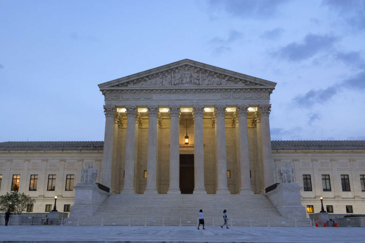 People walk near the U.S. Supreme Court building at dusk on July 8, 2026, in Washington, D.C.