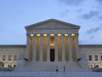 People walk near the U.S. Supreme Court building at dusk on July 8, 2026, in Washington, D.C.
