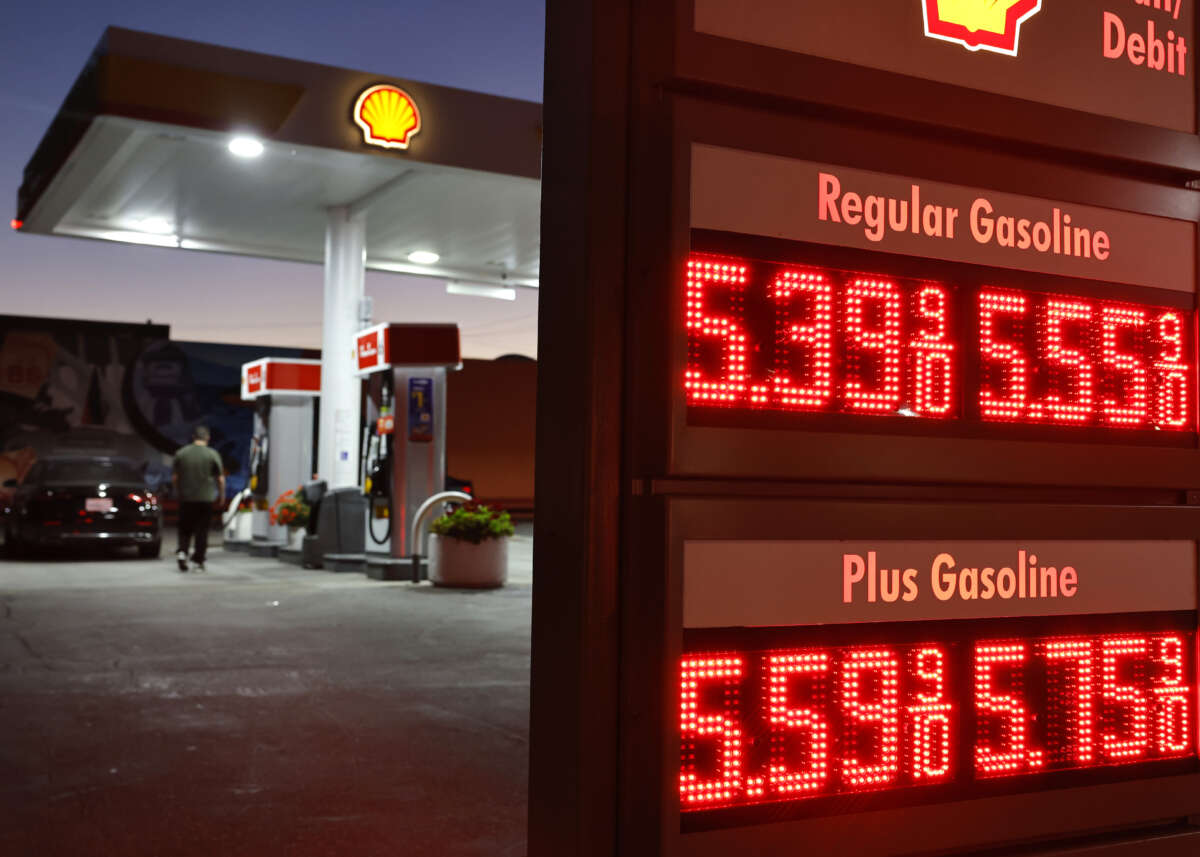 A customer walks near gas prices displayed at a Shell gas station on July 7, 2026 in Pasadena, California.