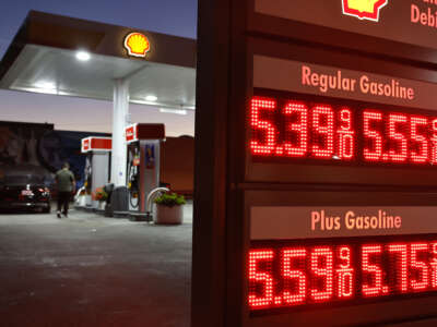 A customer walks near gas prices displayed at a Shell gas station on July 7, 2026 in Pasadena, California.