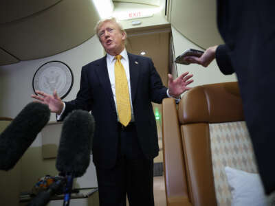 U.S. President Donald Trump speaks to members of the press for the first time aboard the new Air Force One while in flight from RAF Mildenhall AFB to Joint Base Andrews on July 8, 2026, after leaving the United Kingdom.