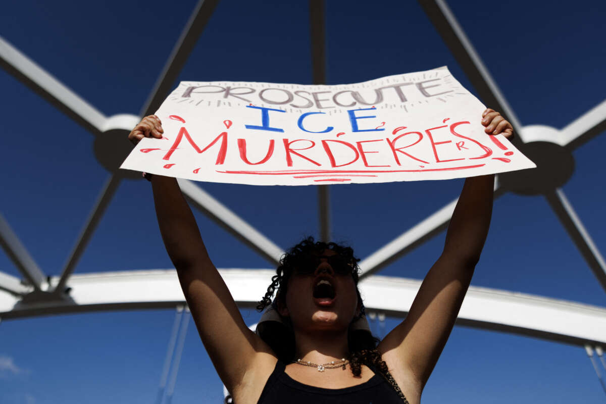 A person holds a sign reading "prosecute ICE murderers" as people gather on a bridge to protest the death of Lorenzo Salgado Araujo, who was fatally shot by a U.S. immigration officer, in Houston, Texas, on July 19, 2026.