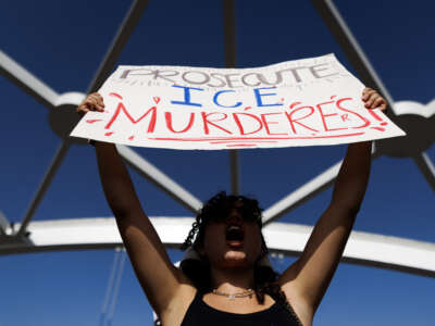 A person holds a sign reading "prosecute ICE murderers" as people gather on a bridge to protest the death of Lorenzo Salgado Araujo, who was fatally shot by a U.S. immigration officer, in Houston, Texas, on July 19, 2026.
