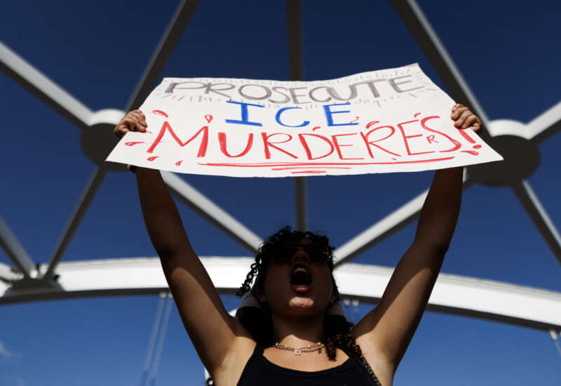 A person holds a sign reading "prosecute ICE murderers" as people gather on a bridge to protest the death of Lorenzo Salgado Araujo, who was fatally shot by a U.S. immigration officer, in Houston, Texas, on July 19, 2026.