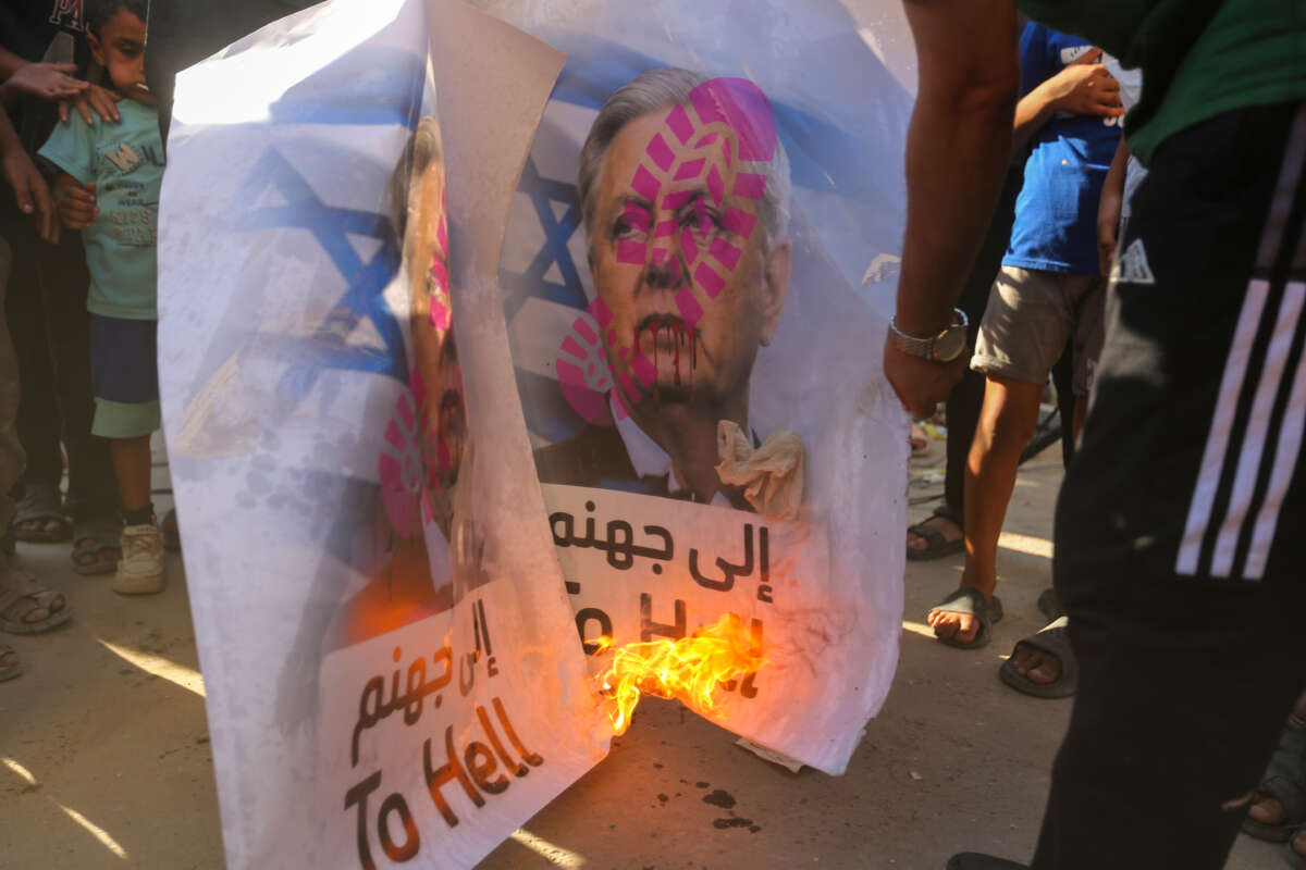 Palestinian refugees burn a picture of Lindsey Graham during a demonstration outside the Al-Shati camp food distribution center, a UNRWA facility, on July 15, 2026, in Gaza City, Gaza.