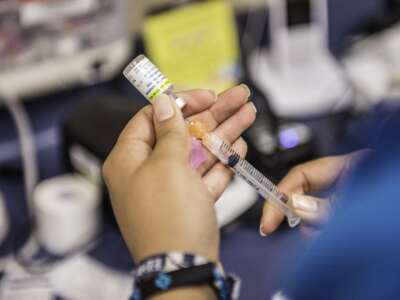 Certified medical assistant Karla Huerta fills a needle with the drug Gardasil, used for HPV vaccinations, at Amistad Community Health Center in Corpus Christi, Texas, on May 27, 2016.