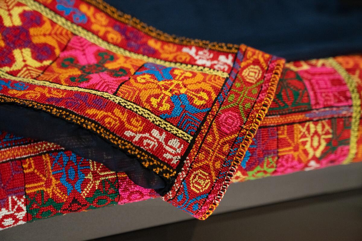 The exhibit contains photos and personal items, including this piece of traditional Palestinian clothing with embroidery known as tatreez.