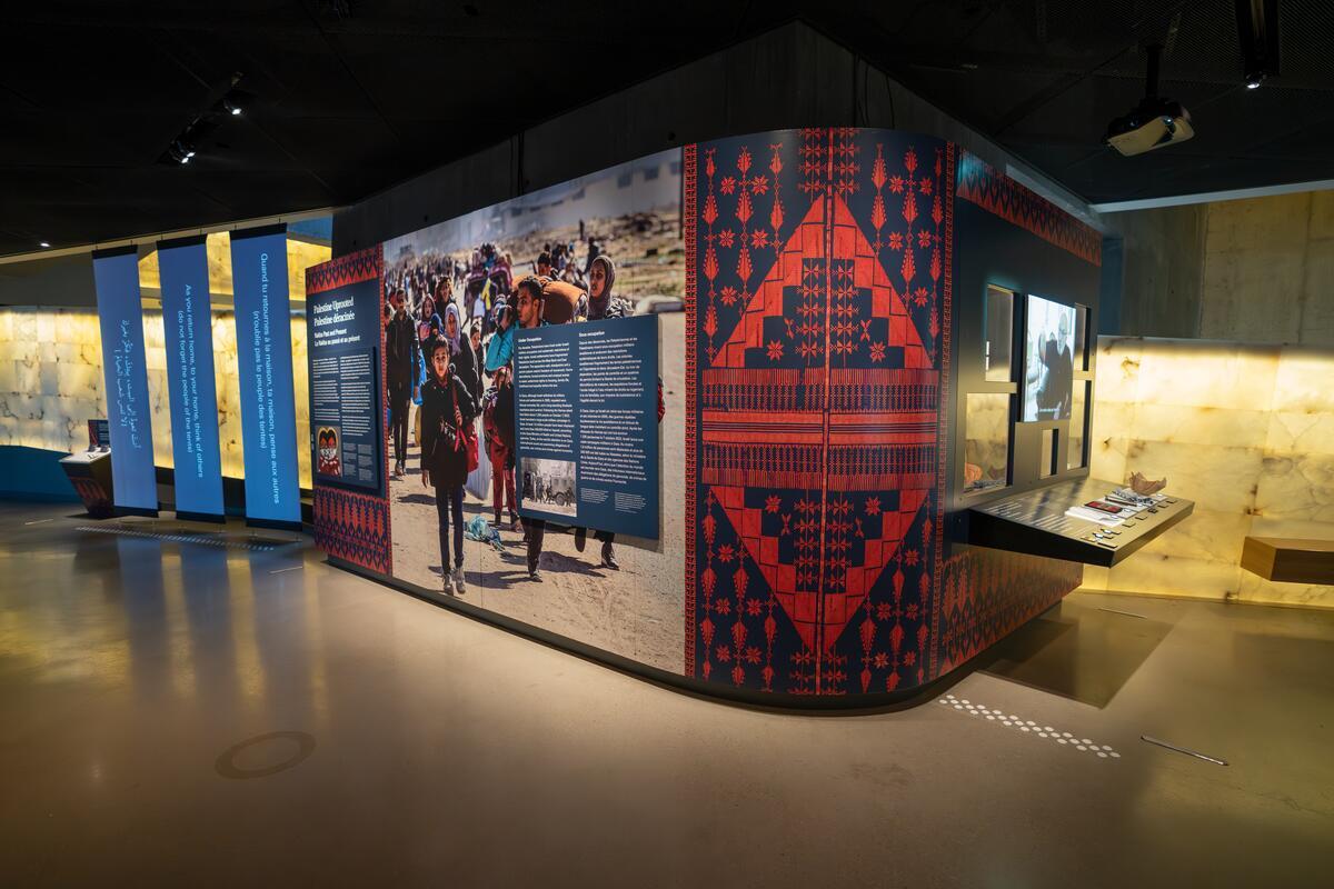 The exhibit measures 12 meters and contains text panels, photos, and video testimonies.
