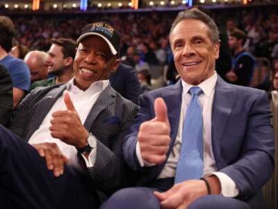 New York Mayor Eric Adams poses with then-mayoral candidate former New York Gov. Andrew Cuomo during the game between the New York Knicks and the Cleveland Cavaliers at Madison Square Garden on October 22, 2025 in New York City.