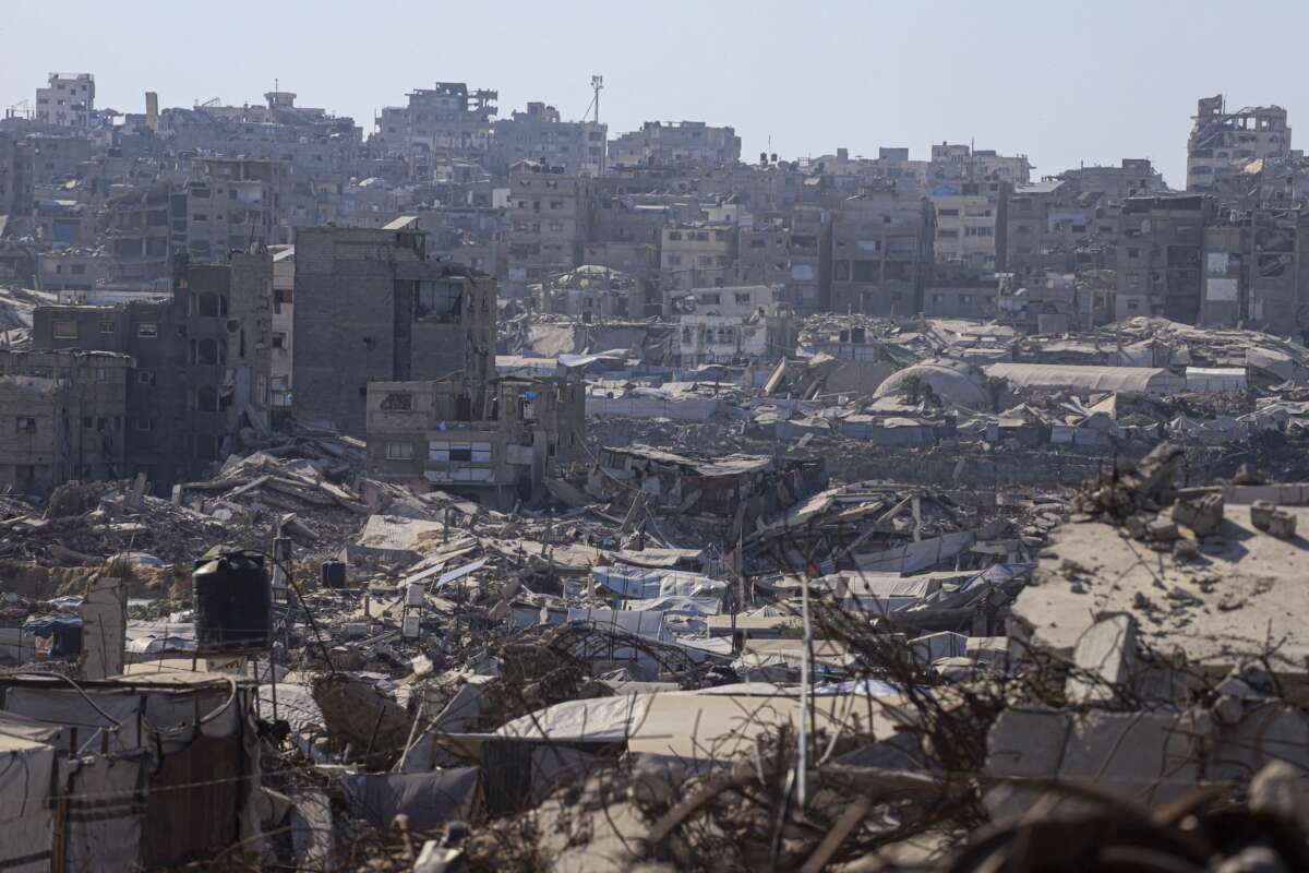 A wide view shows makeshift tents and shelters spread among extensively destroyed buildings during extreme summer heat in Jabalia in the northern Gaza Strip on August 5, 2026.