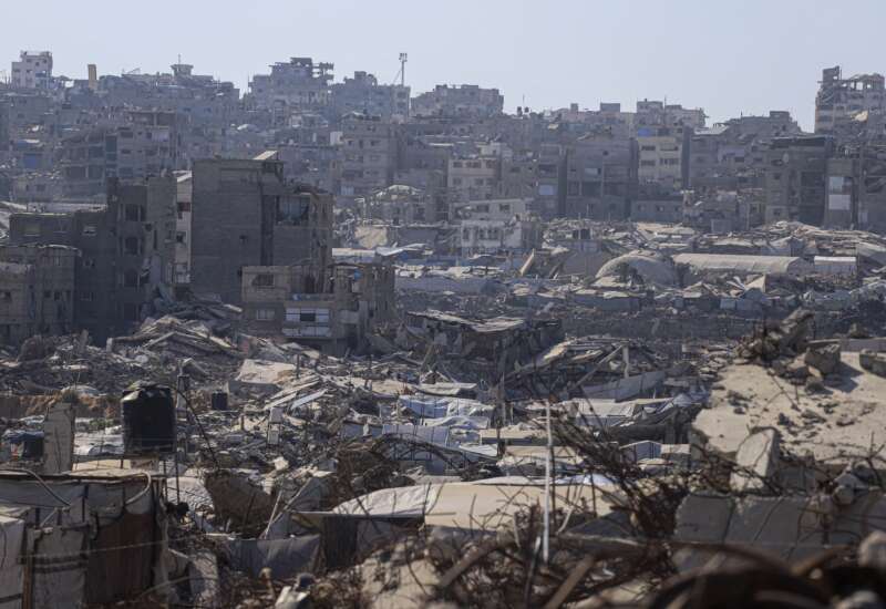 A wide view shows makeshift tents and shelters spread among extensively destroyed buildings during extreme summer heat in Jabalia in the northern Gaza Strip on August 5, 2026.