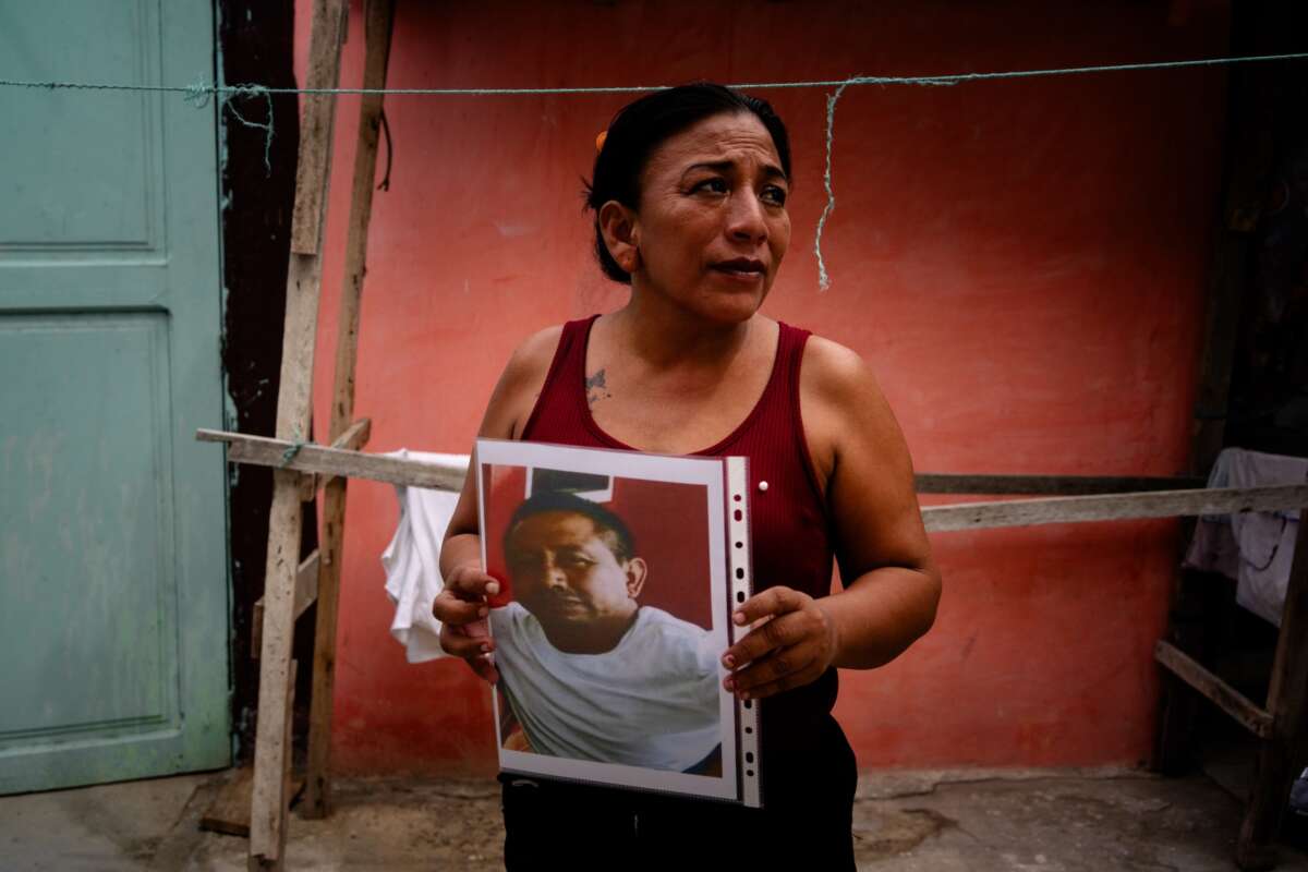 María Mero, 42, holds a photograph of her husband, Gabriel Aladono Mero Delgado, 43, who disappeared as part of the crew aboard the fishing vessel Fiorella, on Sunday, June 7, 2026 in Jaramijó, Ecuador.