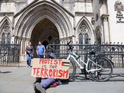 A supporter of Palestine Action demonstrates outside the Royal Courts of Justice as the government appeals the high court ruling that the ban on the activist group Palestine Action is unlawful on April 28, 2026.