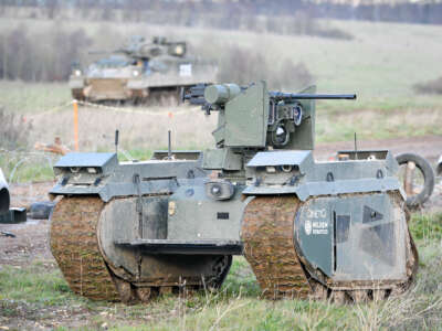 A Titan Strike unmanned ground vehicle, equipped with a .50 Caliber machine gun, moves and secures ground on Salisbury Plain during exercise Autonomous Warrior 18.