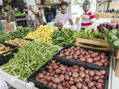 Red potatoes, green beans, and yellow squash are seen at the Charlotte Regional Farmers Market in Charlotte, North Carolina, on June 7, 2023.