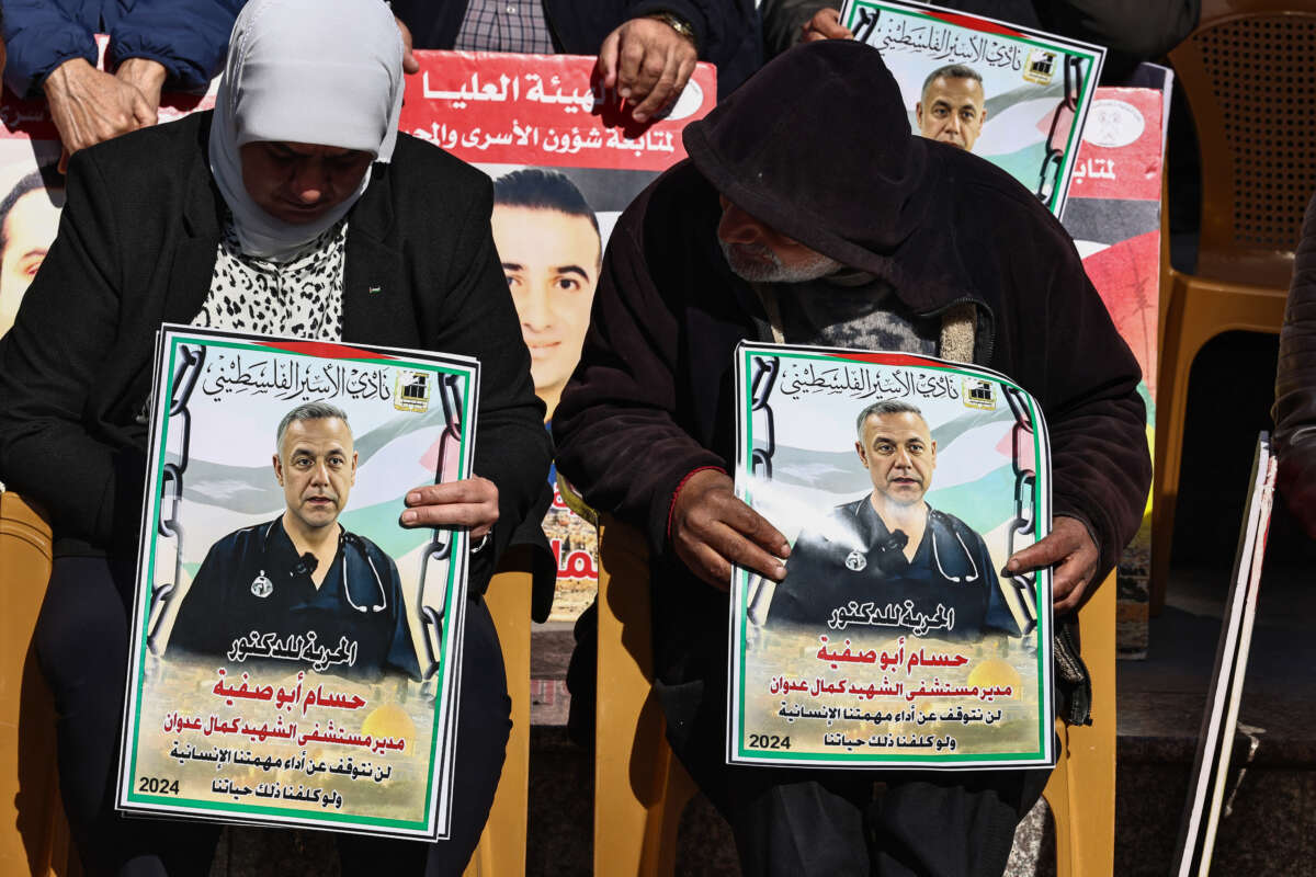 People lift placards bearing portraits of Palestinians currently detained by Israel, including the director of the Kamal Adwan Hospital in Gaza Dr. Hussam Abu Safiya, during a protest in solidarity with them in Ramallah city in the occupied West Bank, on January 14, 2025.