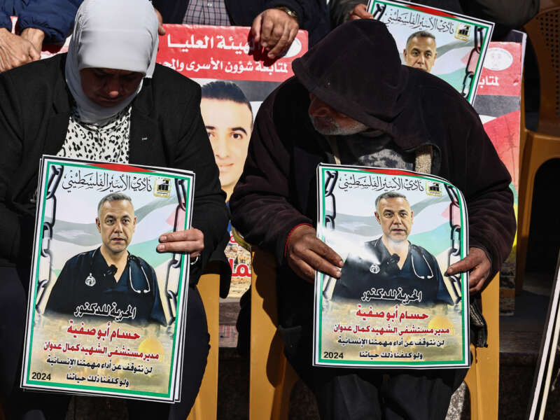 People lift placards bearing portraits of Palestinians currently detained by Israel, including the director of the Kamal Adwan Hospital in Gaza Dr. Hussam Abu Safiya, during a protest in solidarity with them in Ramallah city in the occupied West Bank, on January 14, 2025.