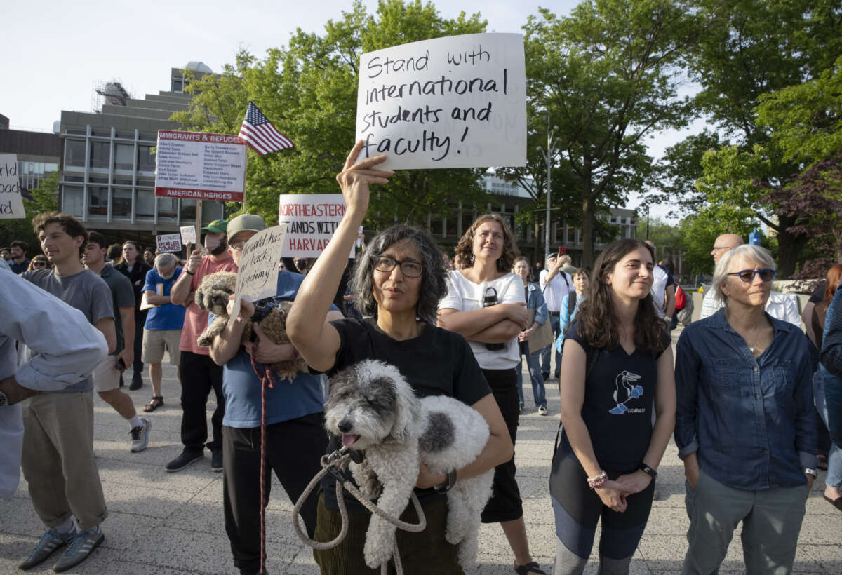 People hold up signs during the Harvard Students for Freedom rally in support of international students at the Harvard University campus in Cambridge, Massachusetts, on May 27, 2025.