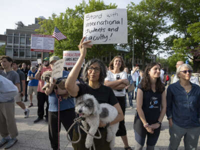 People hold up signs during the Harvard Students for Freedom rally in support of international students at the Harvard University campus in Cambridge, Massachusetts, on May 27, 2025.