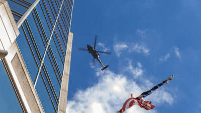 A US flag is seen as a police helicopter circles a protest march through downtown Memphis, Tennessee, in opposition to the increase of federal law enforcement agents, the coming deployment of the National Guard and xAI, an AI company owned by Elon Musk that is locally based, during the "Get Out of Memphis" protest on October 4, 2025.