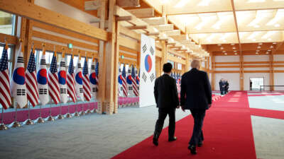 U.S. and South Korean flags line the hall as U.S. President Donald Trump is welcomed by South Korean President Lee Jae Myung at the Gyeongju National Museum on October 29, 2025, in Gyeongju, South Korea.