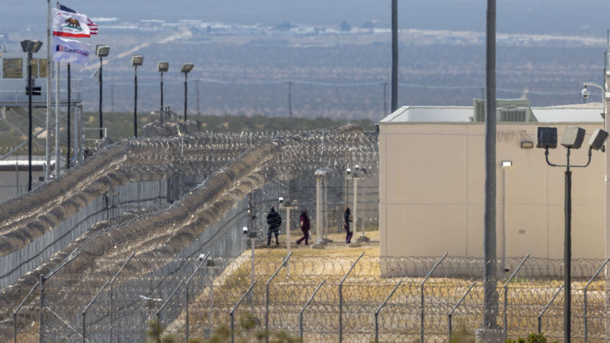 People enter the California City Immigration Processing Center, the state's newest and largest ICE prison, on March 25, 2026 in California City, California.