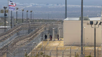 People enter the California City Immigration Processing Center, the state's newest and largest ICE prison, on March 25, 2026 in California City, California.