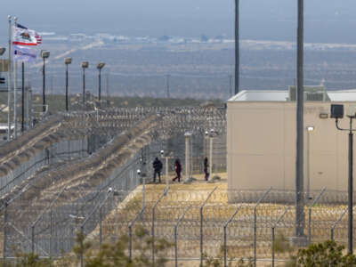 People enter the California City Immigration Processing Center, the state's newest and largest ICE prison, on March 25, 2026 in California City, California.