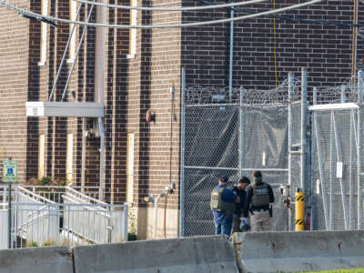 Federal agents bring a detainee into the Immigration and Customs Enforcement holding facility in Broadview, Illinois, on October 18, 2025.