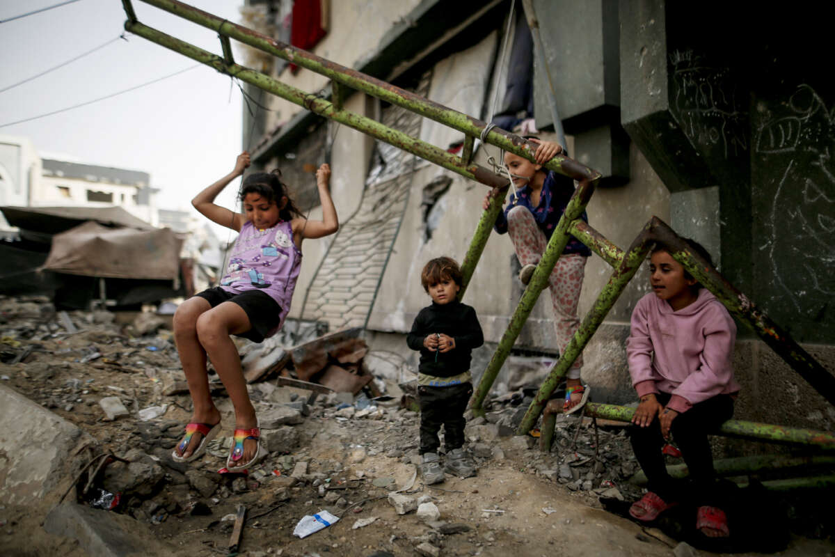 Displaced Palestinian children play inside a damaged building at the Islamic University in Gaza City, on April 18, 2026.
