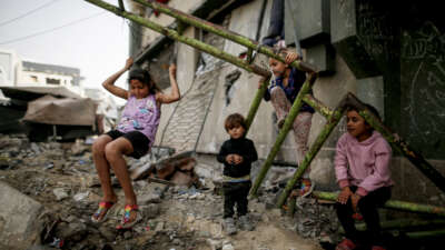 Displaced Palestinian children play inside a damaged building at the Islamic University in Gaza City, on April 18, 2026.
