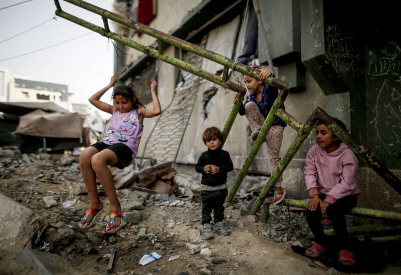 Displaced Palestinian children play inside a damaged building at the Islamic University in Gaza City, on April 18, 2026.