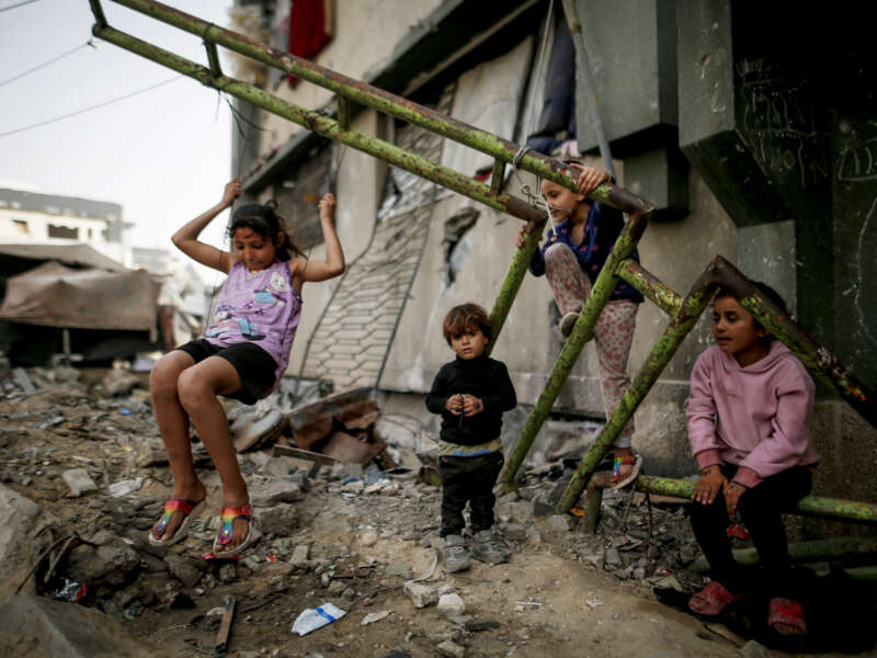 Displaced Palestinian children play inside a damaged building at the Islamic University in Gaza City, on April 18, 2026.