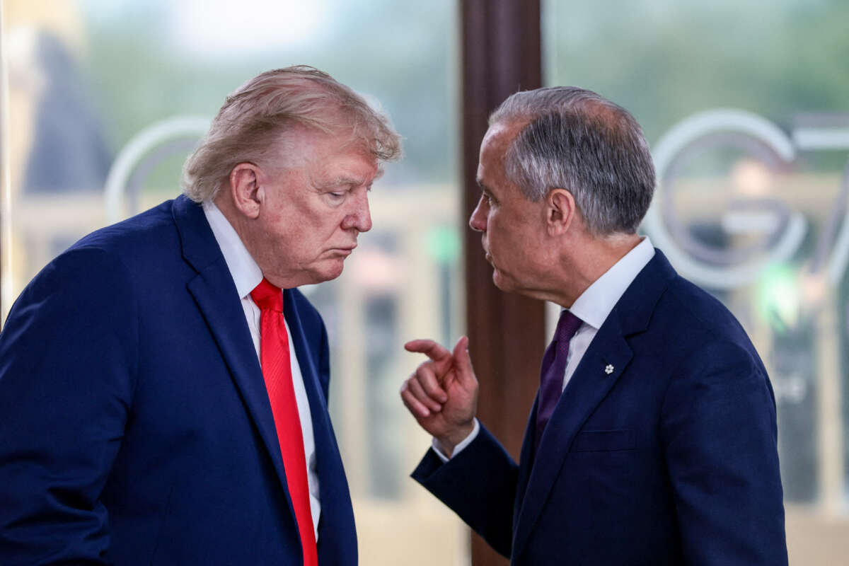 U.S. President Donald Trump speaks with Canada's Prime Minister Mark Carney during a work lunch as part of the G7 summit, in Evian, eastern France, on June 16, 2026.