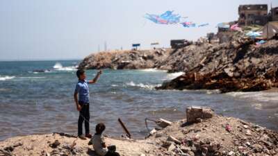 A Palestinian child flies a kite near the beach in Gaza City, Palestine, on June 19, 2026.