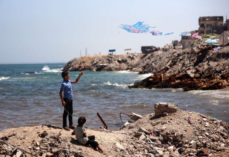 A Palestinian child flies a kite near the beach in Gaza City, Palestine, on June 19, 2026.