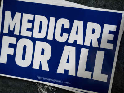 A Medicare for All sign is displayed before Michigan Democratic candidate for Senate Abdul El-Sayed speaks at The People V. The Powerful rally at the Detroit Opera House on July 18, 2026, in Detroit, Michigan.