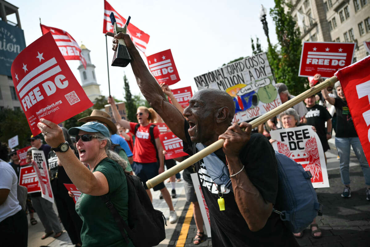 Demonstrators rally during a "FreeDC" protest in Washington, D.C., on August 11, 2026, to mark one year since U.S. President Donald Trump deployed members of the National Guard into the city.