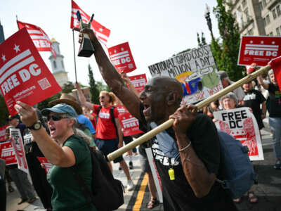 Demonstrators rally during a "FreeDC" protest in Washington, D.C., on August 11, 2026, to mark one year since U.S. President Donald Trump deployed members of the National Guard into the city.